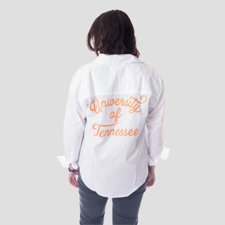 A white collared shirt with embroidered University of Tennessee on the back.